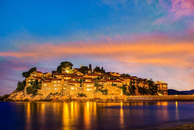 Fiery sky over Sveti Stefan island at sunset, Montenegro