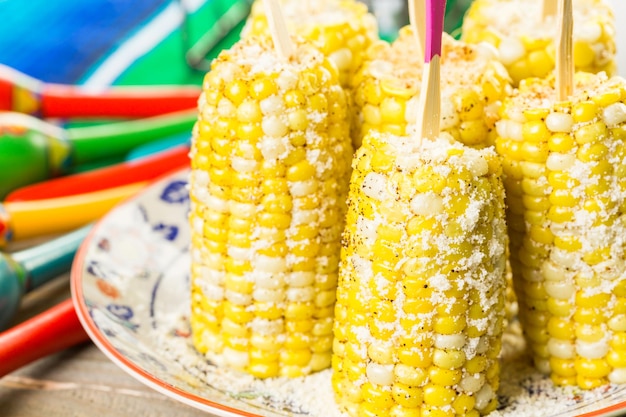 Fiesta party buffet table with spicy mexican corn on the cob and other traditional Mexican food.