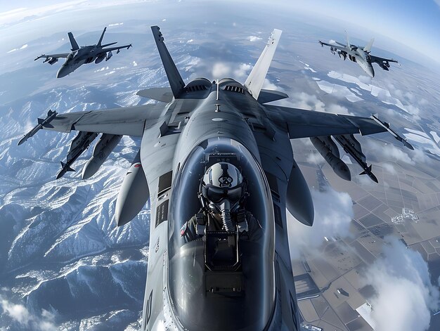 Photo fighter jet pilots flying in formation above snowcovered mountains during a clear day