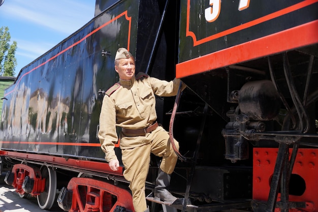 Fighter of Red Army in the form of times of World War II on a footboard of the old engine