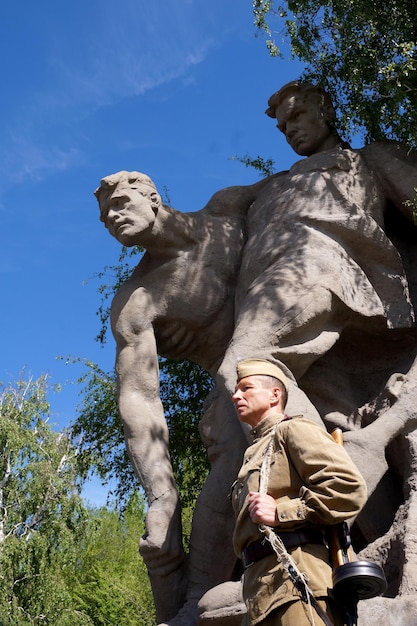 Fighter of Red Army in the form of times of World War II with the machine gun at a historical monument  on Mamayev Kurgan in Volgograd