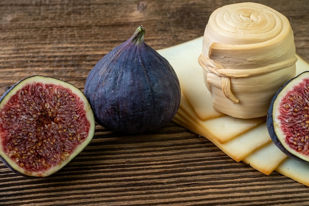 Figs various cheese on a rustic tableTraditional hand made slovak smoked cheese parenica