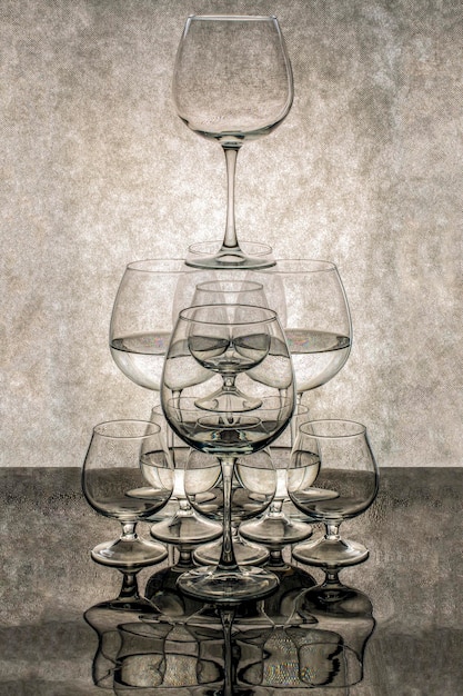 A figure from different glasses with liquid with reflection