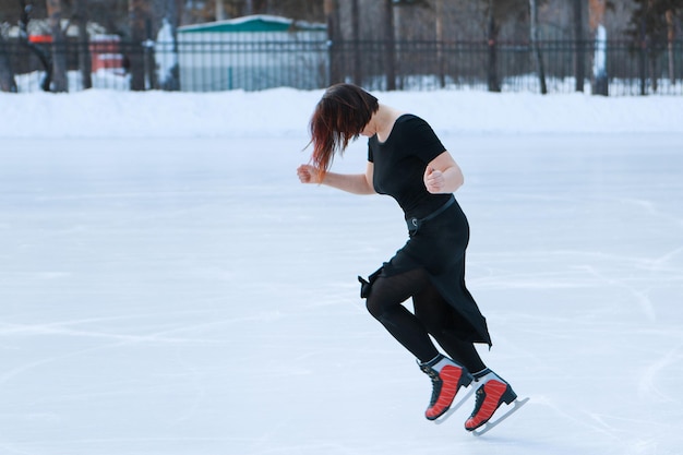 Figure skater on ice the girl is skating ice under the open sky no makeup in winter red cheeks