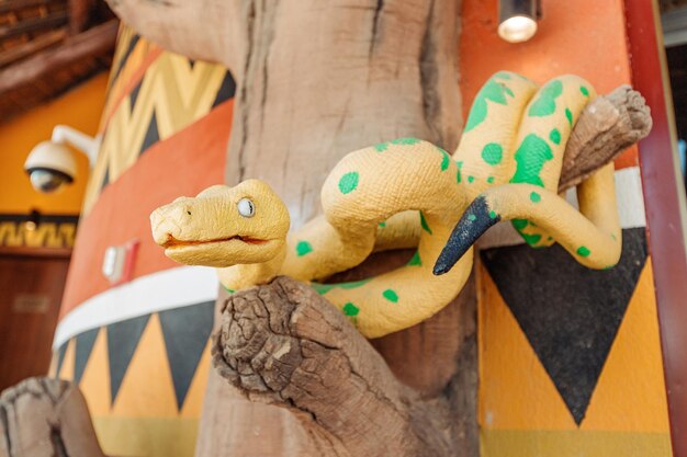 Figure of a yellow snake with venomous pattern at the entrance to the Serpentarium entertainment and tourist center