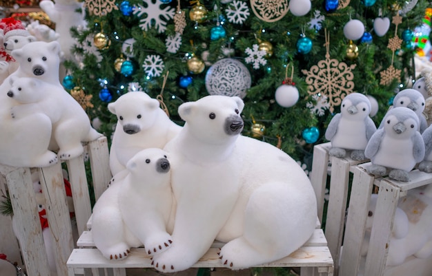 Figurine polar bears toy, near the Christmas tree. Christmas decor, xmas tree decorations.