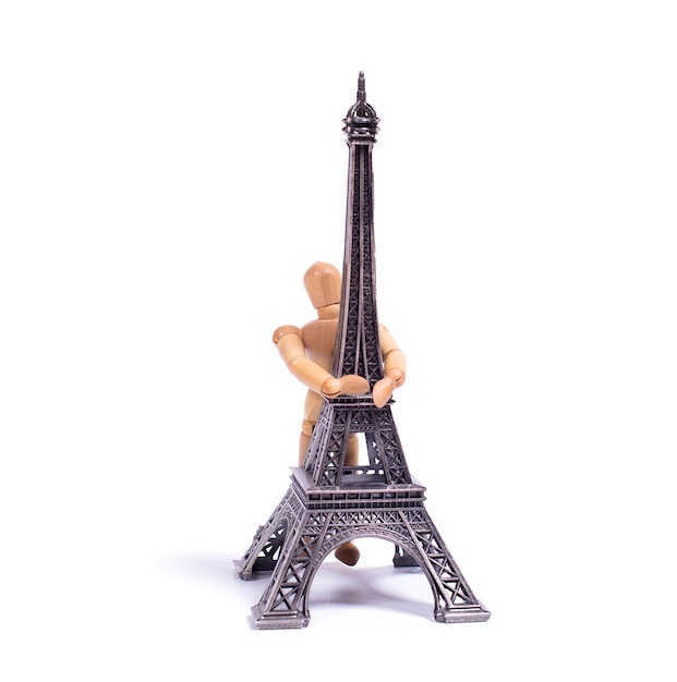 Photo a figurine that is holding a tower with the word paris on it