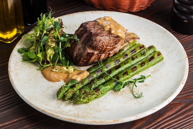 Filet mignon with asparagus on wooden background