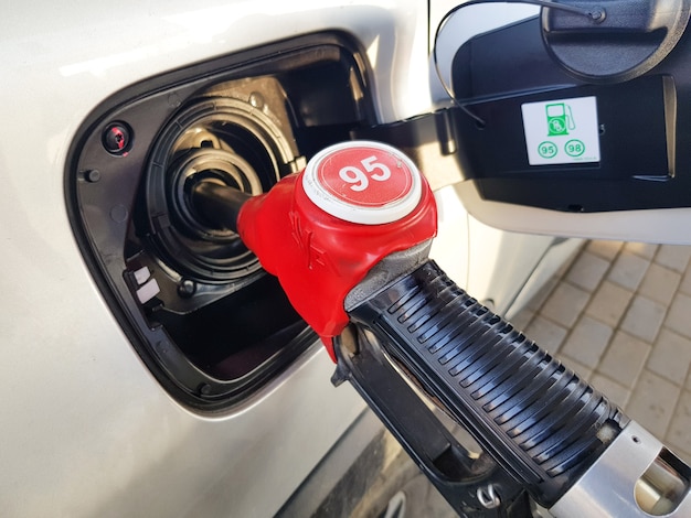 Filling the car with gasoline Insert the red gun into the tank of the car for refueling