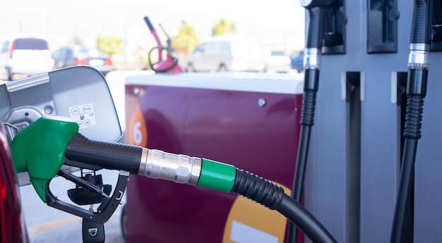 Photo filling fuel into the car tank at the pump service station for concept transportation power business rising prices inflation