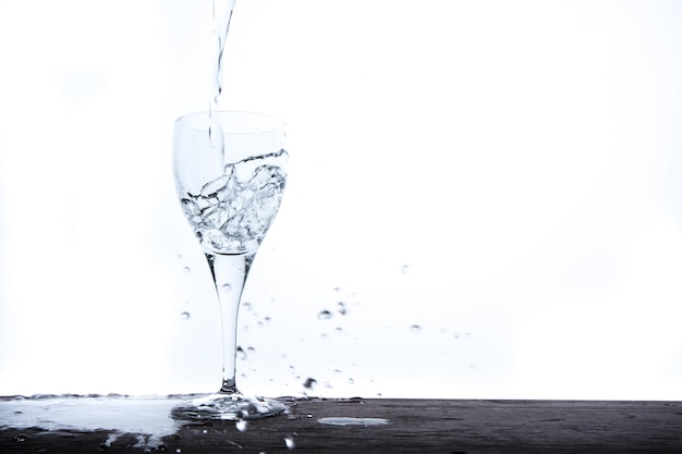 Filling glass with water fall on table