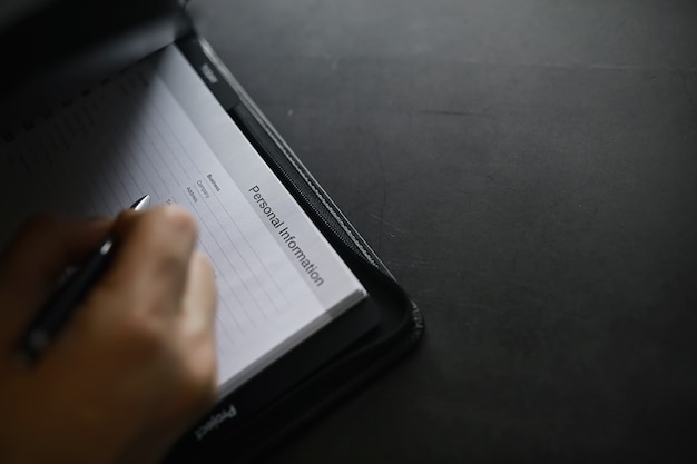 Filling out a form with personal information Documents in a folder on the table to fill