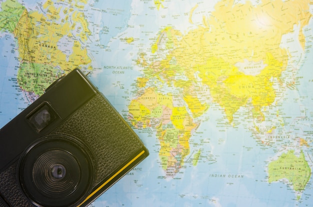 Film camera lay on world map