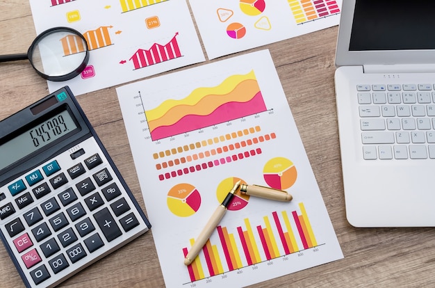 Finance analyst working place with magnifying glass