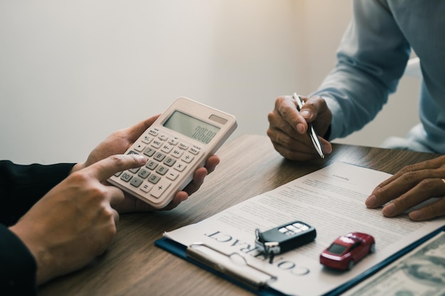 Finance manager of the car showroom is calculating the cost of reserving a new car for the customer while signing a car purchase contract