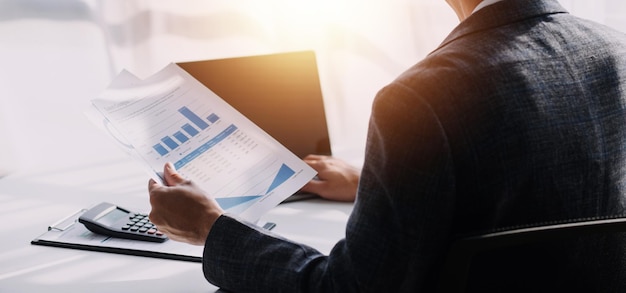 Financial analysts analyze business financial reports on a digital tablet planning investment project during a discussion at a meeting of corporate showing the results of their successful teamwork