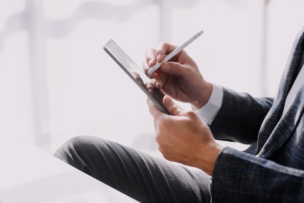 Financial analysts analyze business financial reports on a digital tablet planning investment project during a discussion at a meeting of corporate showing the results of their successful teamwork