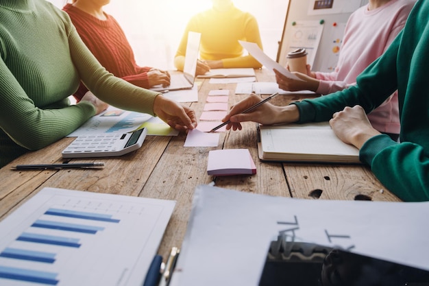 Financial analysts analyze business financial reports on a digital tablet planning investment project during a discussion at a meeting of corporate showing the results of their successful teamwork