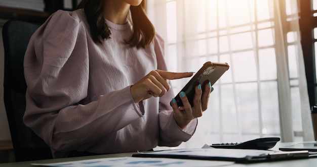 Financial analysts analyze business financial reports on a digital tablet planning investment project during a discussion at a meeting of corporate showing the results of their successful teamwork