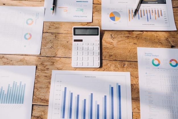 Financial analysts analyze business financial reports on a digital tablet planning investment project during a discussion at a meeting of corporate showing the results of their successful teamwork