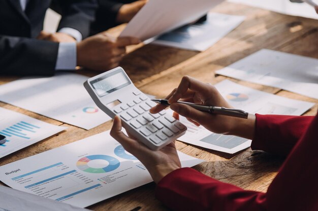 Financial analysts analyze business financial reports on a digital tablet planning investment project during a discussion at a meeting of corporate showing the results of their successful teamwork