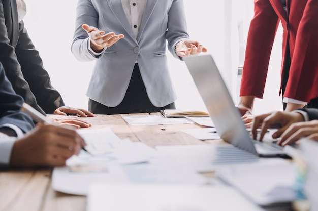 Financial analysts analyze business financial reports on a digital tablet planning investment project during a discussion at a meeting of corporate showing the results of their successful teamwork