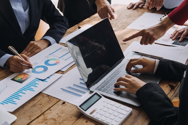 Financial analysts analyze business financial reports on a digital tablet planning investment project during a discussion at a meeting of corporate showing the results of their successful teamwork