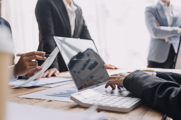 Financial analysts analyze business financial reports on a digital tablet planning investment project during a discussion at a meeting of corporate showing the results of their successful teamwork