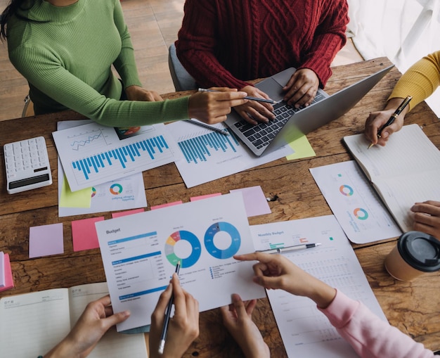 Financial analysts analyze business financial reports on a digital tablet planning investment project during a discussion at a meeting of corporate showing the results of their successful teamwork