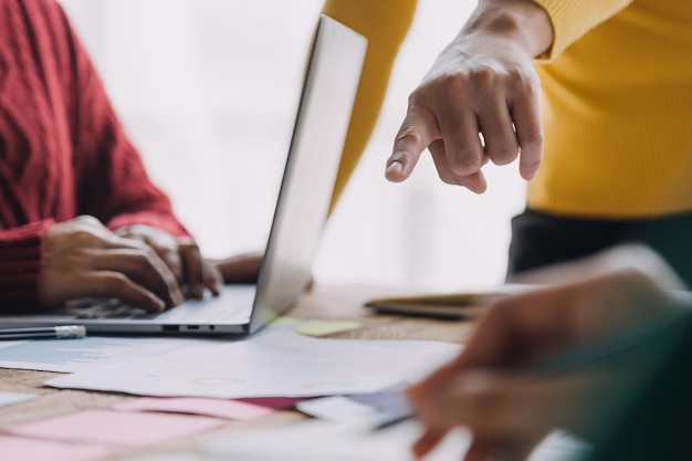 Financial analysts analyze business financial reports on a digital tablet planning investment project during a discussion at a meeting of corporate showing the results of their successful teamwork