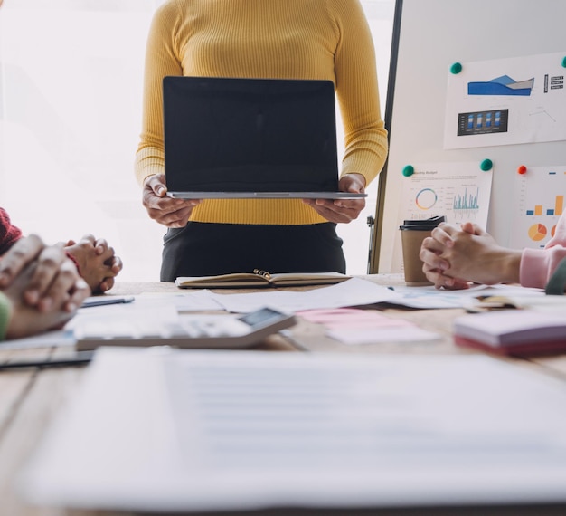 Financial analysts analyze business financial reports on a digital tablet planning investment project during a discussion at a meeting of corporate showing the results of their successful teamwork