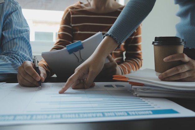 Financial analysts analyze business financial reports on a digital tablet planning investment project during a discussion at a meeting of corporate showing the results of their successful teamwork