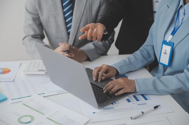 Financial analysts analyze business financial reports on a digital tablet planning investment project during a discussion at a meeting of corporate showing the results of their successful teamwork