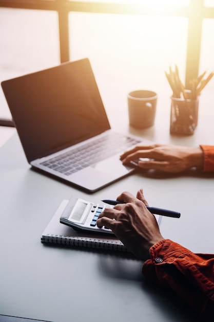 Financial analysts analyze business financial reports on a digital tablet planning investment project during a discussion at a meeting of corporate showing the results of their successful teamwork