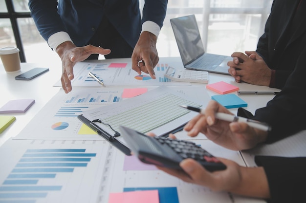 Financial analysts analyze business financial reports on a digital tablet planning investment project during a discussion at a meeting of corporate showing the results of their successful teamwork