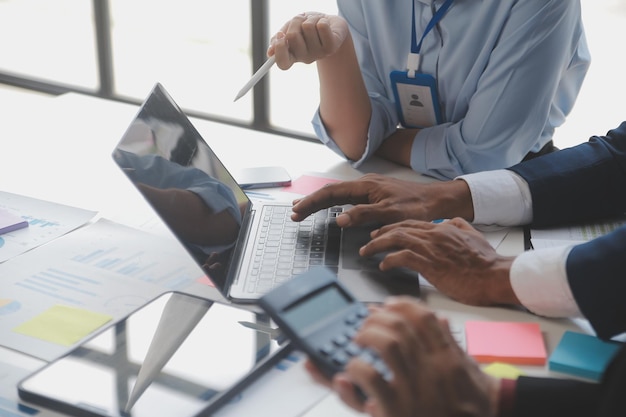 Financial analysts analyze business financial reports on a digital tablet planning investment project during a discussion at a meeting of corporate showing the results of their successful teamwork