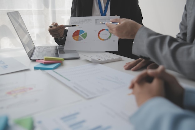 Financial analysts analyze business financial reports on a digital tablet planning investment project during a discussion at a meeting of corporate showing the results of their successful teamwork.