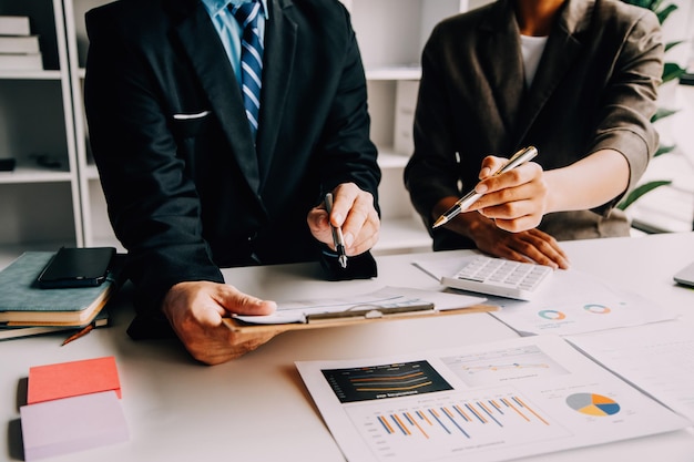 Photo financial analysts analyze business financial reports on a digital tablet planning investment project during a discussion at a meeting of corporate showing the results of their successful teamwork