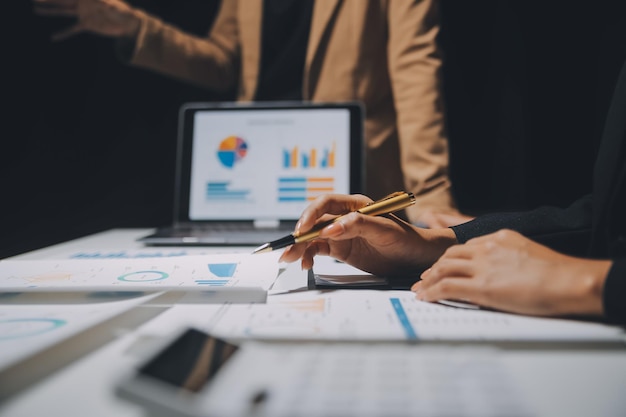 Financial analysts analyze business financial reports on a digital tablet planning investment project during a discussion at a meeting of corporate showing the results of their successful teamwork