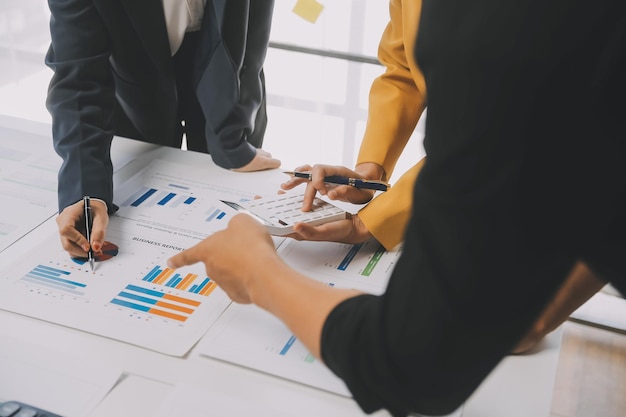 Photo financial analysts analyze business financial reports on a digital tablet planning investment project during a discussion at a meeting of corporate showing the results of their successful teamwork