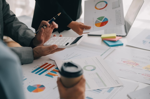 Photo financial analysts analyze business financial reports on a digital tablet planning investment project during a discussion at a meeting of corporate showing the results of their successful teamwork