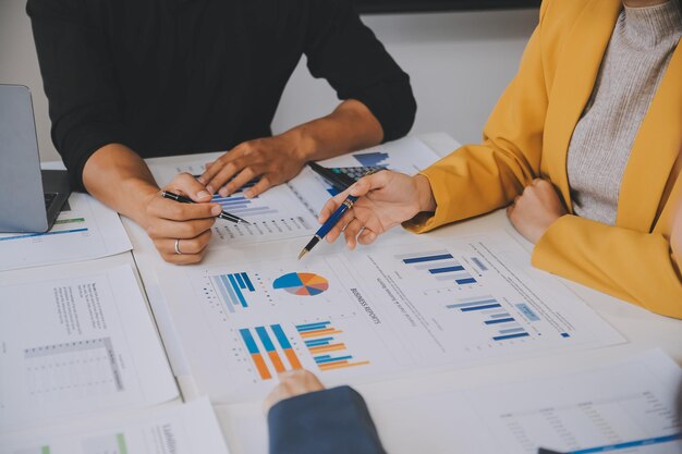 Photo financial analysts analyze business financial reports on a digital tablet planning investment project during a discussion at a meeting of corporate showing the results of their successful teamwork