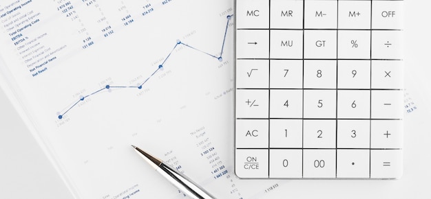 Financial charts and a calculator on the accountant's desk. Calculating profits, taxes, and paying employees salaries.