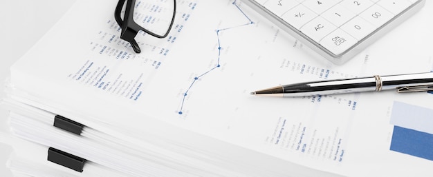 Financial charts and a calculator on the accountants desk