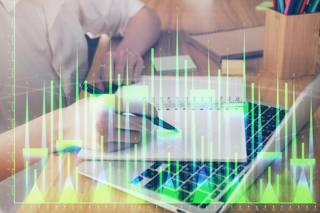 Financial charts displayed on woman's hand taking notes background Concept of research Double exposure