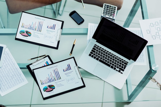 Financial charts, marketing diagrams,laptop and calculator at the workplace of the businessman  