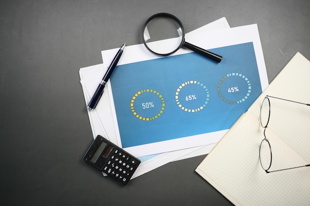 Financial graph calculator and notepad on table