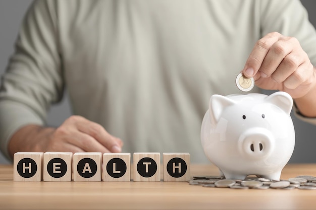 Financial for health concept The idea of saving money for health and life Man putting coin to white piggy bank on desk Health health check up or saving money concept