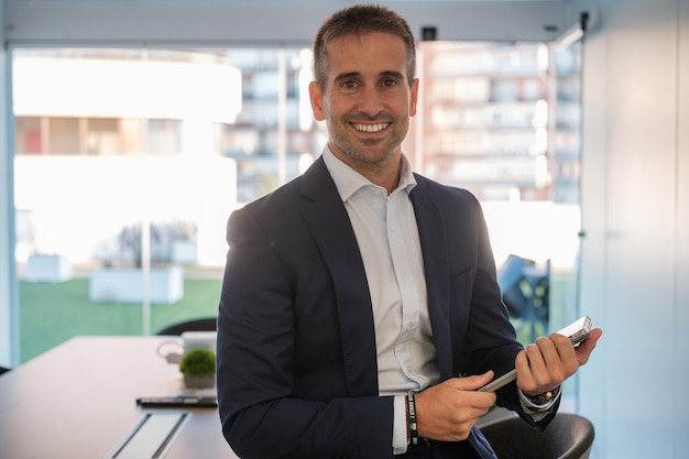 Financial manager sitting on the office table with tablet in hand Concept business corporate boss