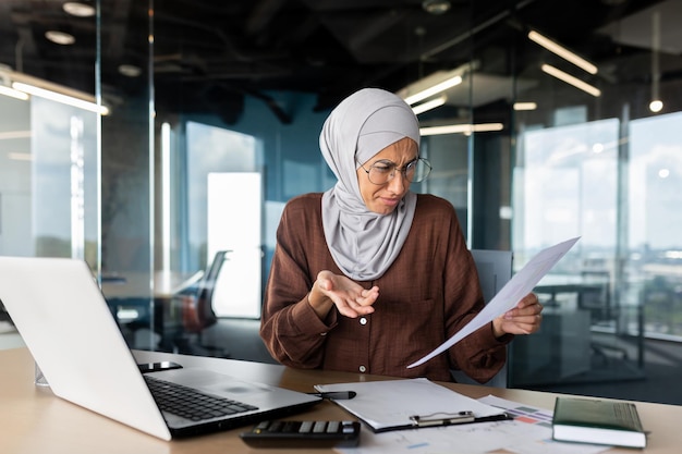 Financial problems broken contracts agreements confused young muslim hijabi businesswoman sitting in